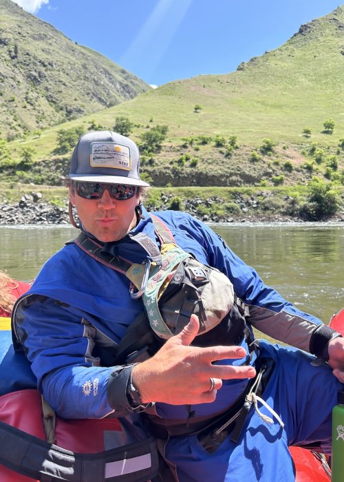 ROW river guide posing on a raft.