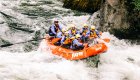 A group of whitewater rafters in a red raft on the Lochsa River in Idaho