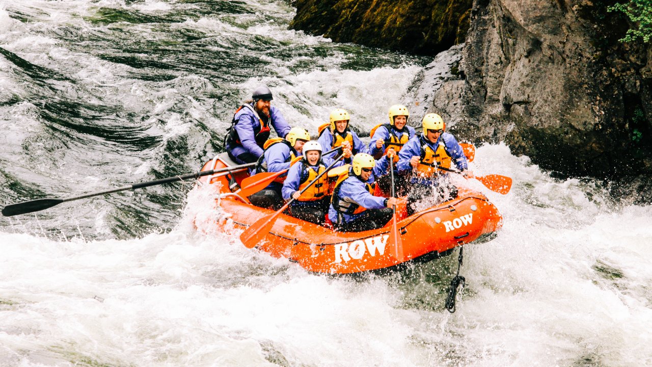 A group of whitewater rafters in a red raft on the Lochsa River in Idaho