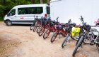 Line of Pedego E bike lined up outside of a sprinter van for a group bike tour