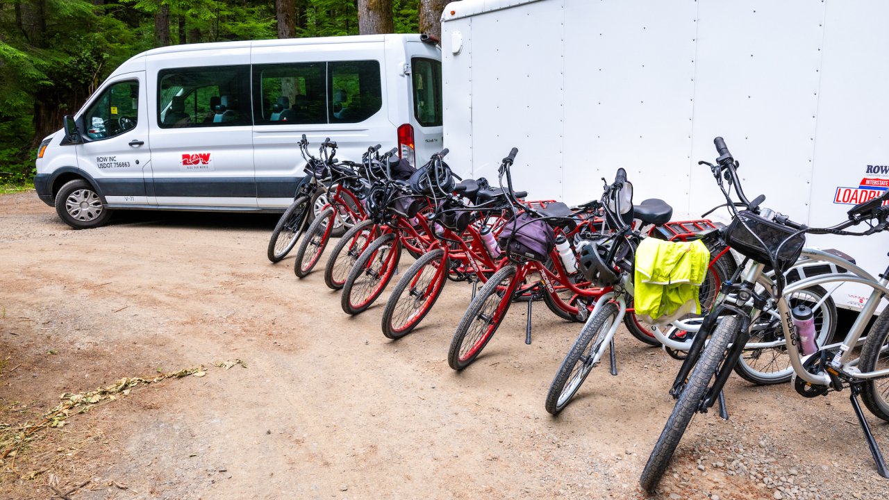 Line of Pedego E bike lined up outside of a sprinter van for a group bike tour