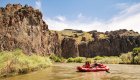 People paddling through a rapid in southern Idaho on a sunny day