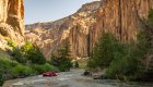 A red raft curving around a river bend between canyon ways on the Bruneau River in Idaho