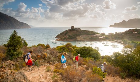 People walking on a trail along the Mediterranean Sea on the island of Corsica