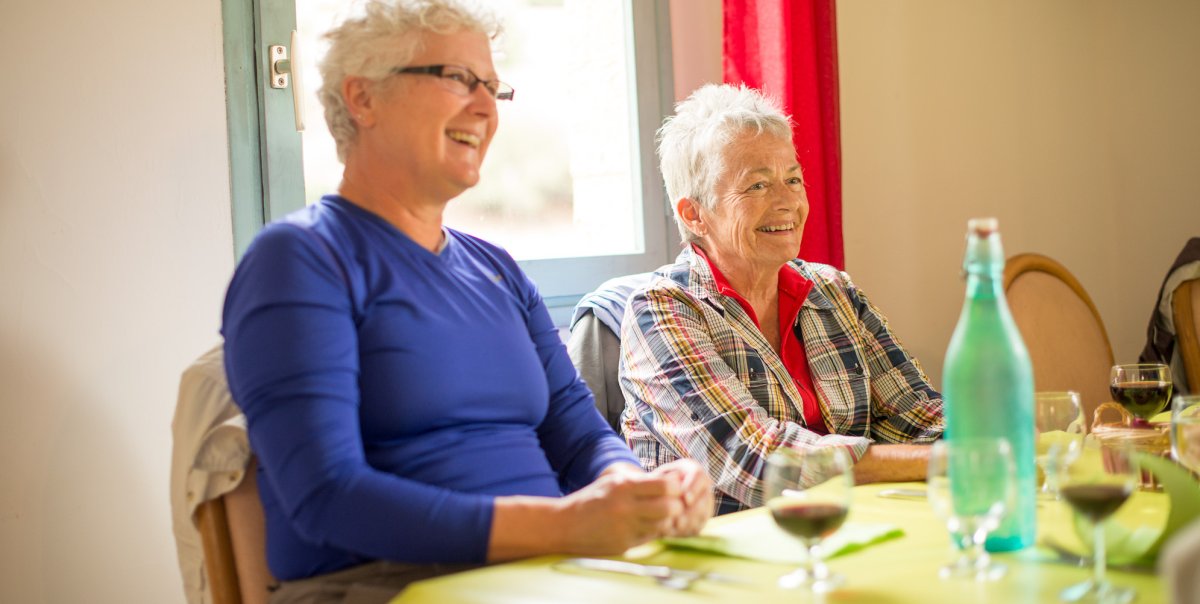 Two guests enjoying red wine at the dinner table in Corsica