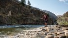 Person casting a fly fishing line into the Middle Fork Salmon River from a rocky river bed