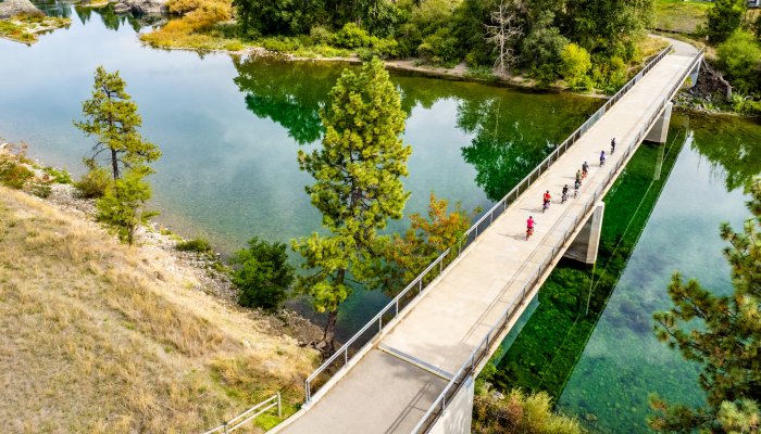 People riding e-bikes on the Centennial Trail in Northern Idaho