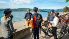 A group of people standing around their bikes in Northern Idaho on a sunny day