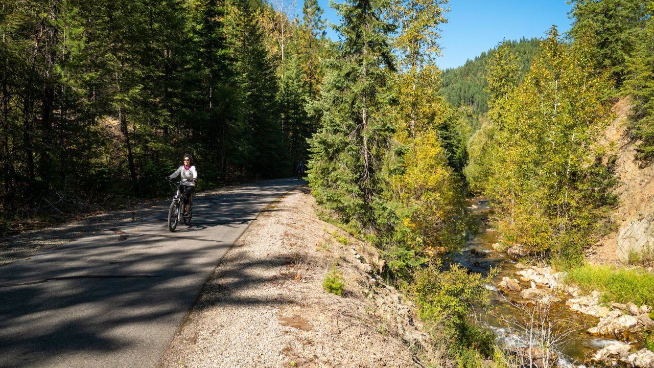 Person on a paved bike trail next to a river
