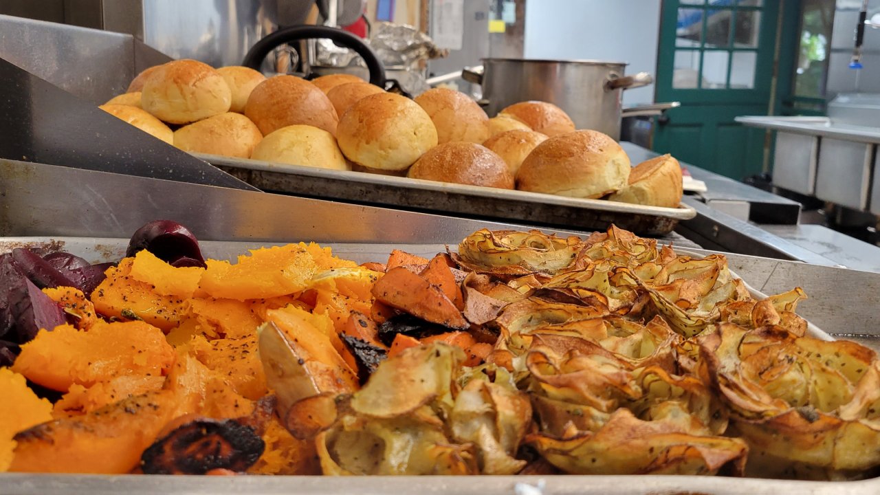 Sweet potatoes, beets, and rolls on baking trays