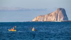 Two sea kayaks paddling near Kicker Rock in the Pacific 