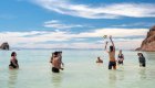 Group of guests playing an impromptu game of beach volleyball at camp