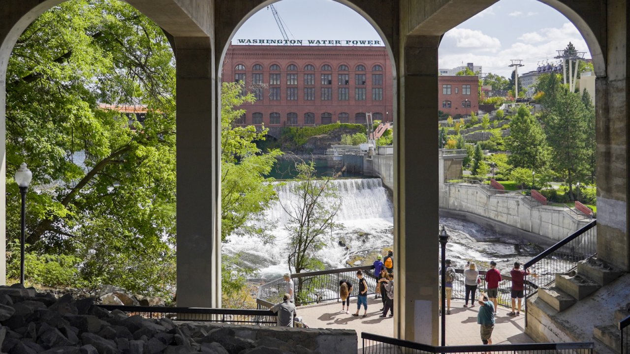 people standing on a platform overlooking a waterfall