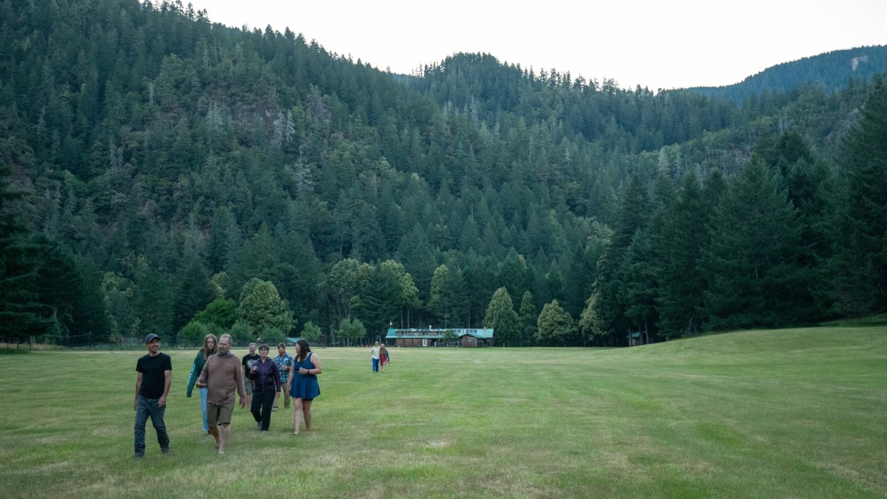People walking down an airstrip with Half Moon Bar Lodge in the background