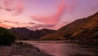 A pink Idaho sky as the sun sets over the Snake river in Hells Canyon.