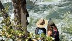 Two women scouting a class IV rapid on the Deschutes River in Oregon