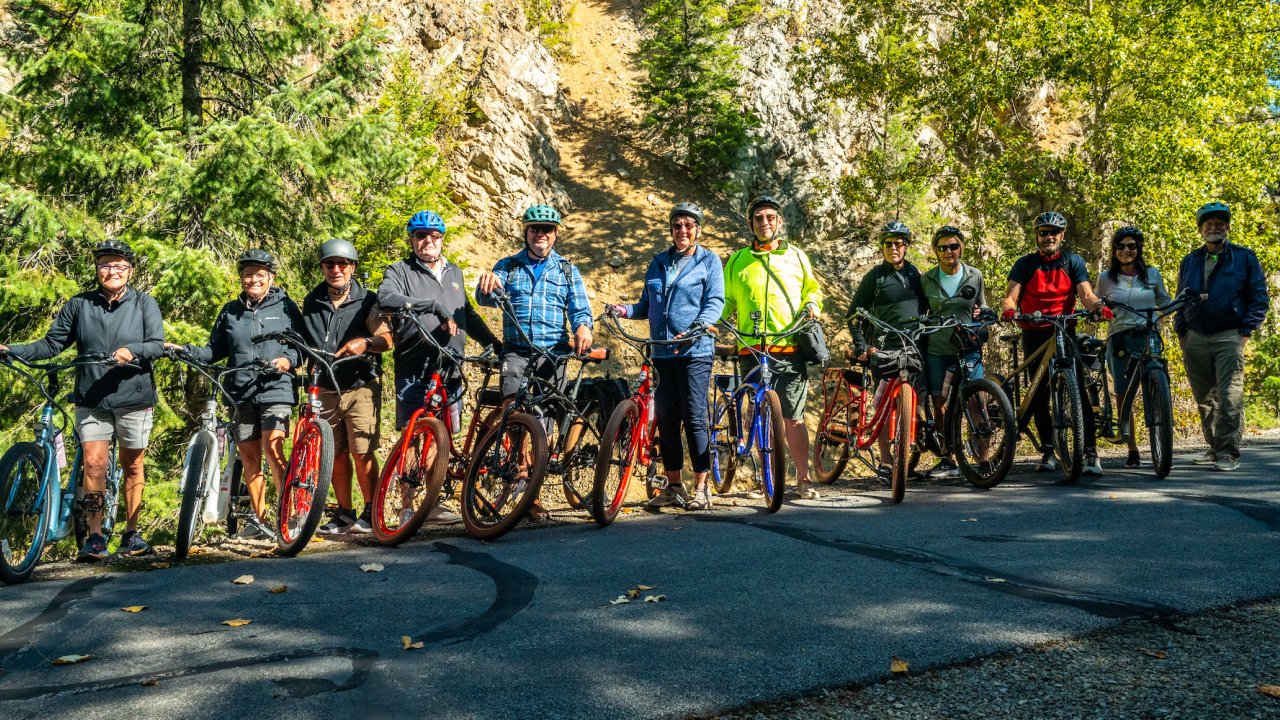 A group of people standing on their bikes in Idaho on a sunny day
