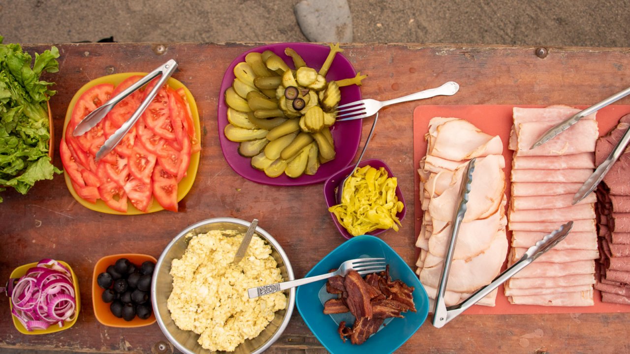 lunch meat and sandwich toppings on table