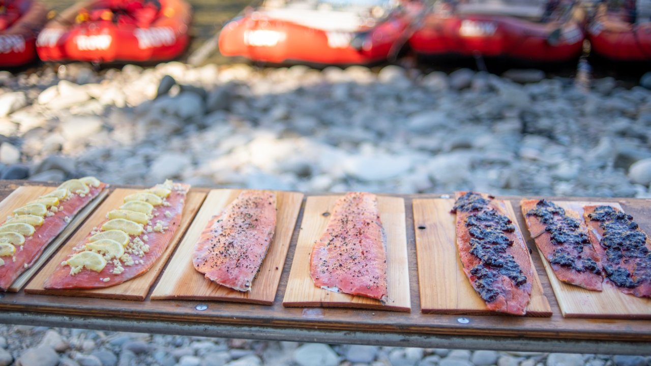Fresh salmon fillets prepared on cedar planks for cooking during a wilderness rafting trip on the Middle Fork of the Salmon River in Idaho.