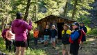 group standing the the woods by old cabin