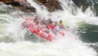 ROW Adventures raft going through a large rapid in Montana. 