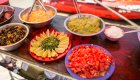 A variety of food displayed on a table at a beach along the Salmon river.