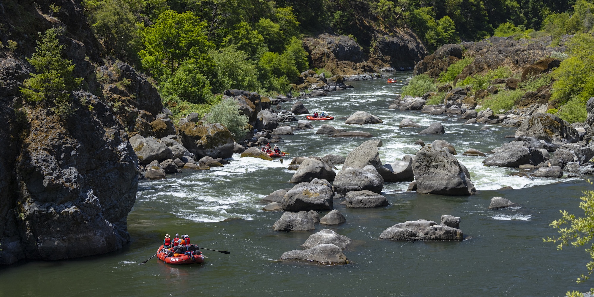 Rafts threading their way through a technical section of river.