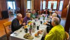 Cyclists enjoy a group meal inside a rustic lodge dining hall on an Olympic Peninsula biking tour in Washington.