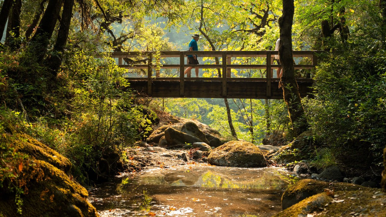 Hiking across a bridge along the Rogue River Corridor