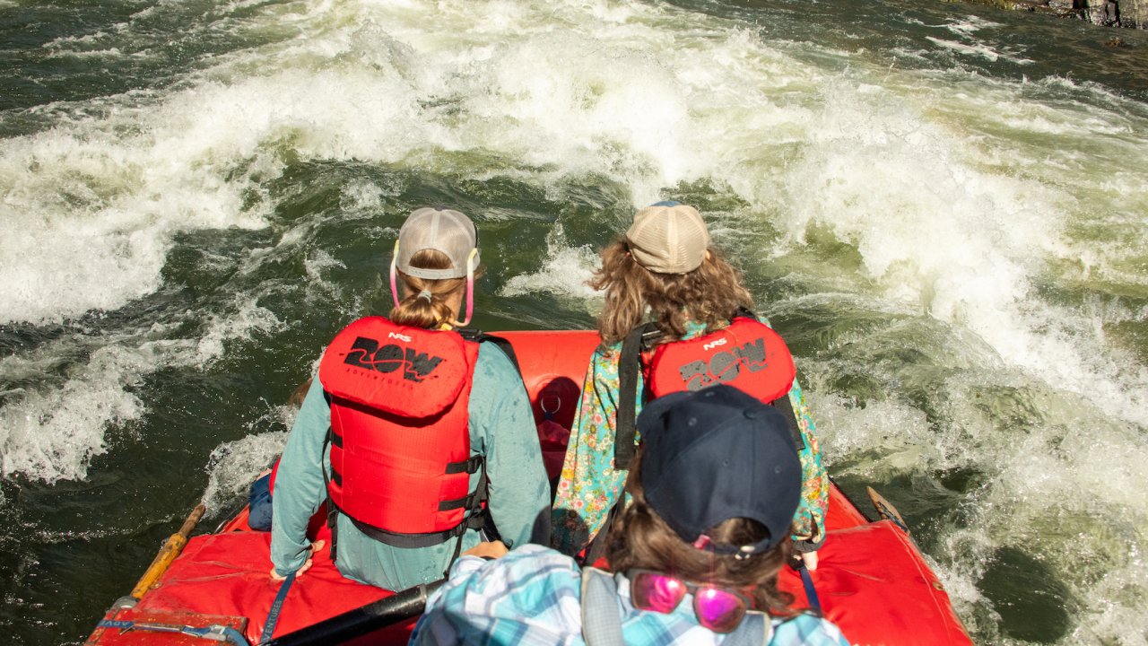 Top down view of a river guide rowing two guests down river