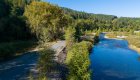 Paved biking trail winding through forested mountains in northern Idaho