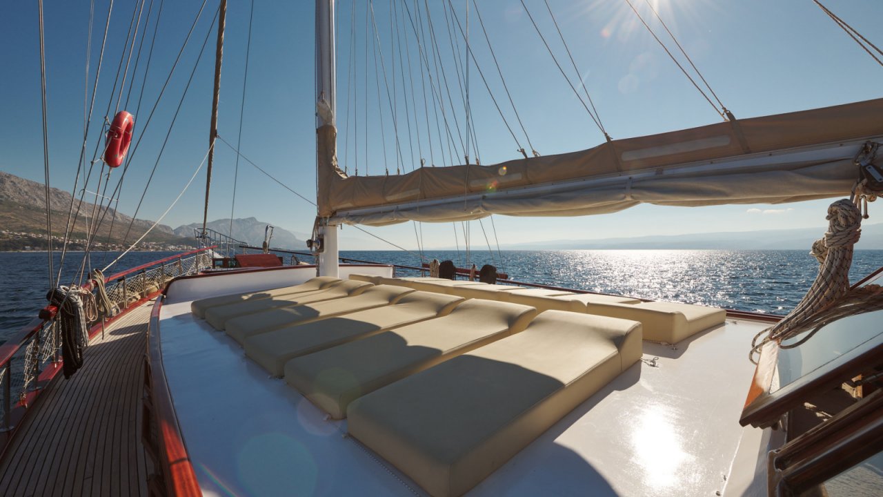 white lounge chairs on a yacht top deck