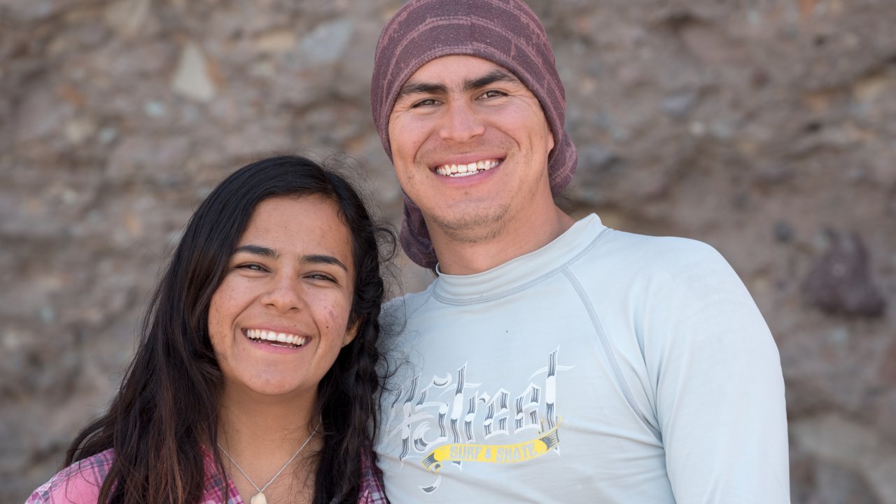 Rafa and Amaranta, comprise part of a very talented Baja Sea Kayak Adventures team. couple standing in front of rock wall