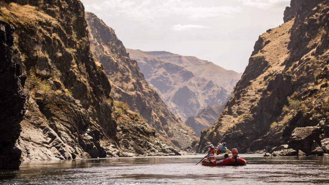 Raft floating through a calm section of Salmon River Canyons.