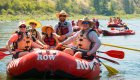 Rafting vacations for families enjoying a calm stretch of river on a guided family rafting trip with matching life vests