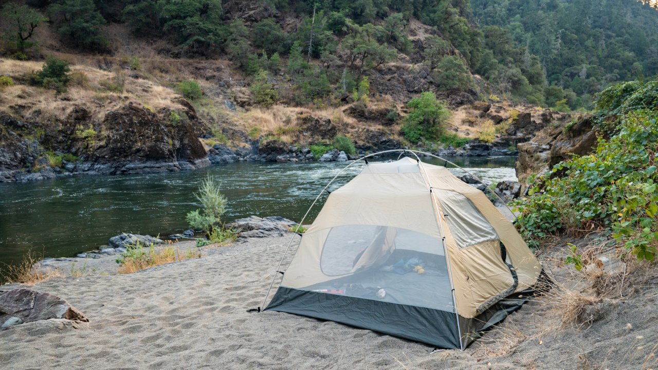 Tent set up on a sandy campsite along the Rogue River in Oregon
