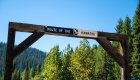 Sign on a wooden arch indicating the start of the Trail of the Hiawatha in Northern Idaho