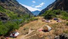 A group of tents set up on a hillside along the Snake River through Hells Canyon
