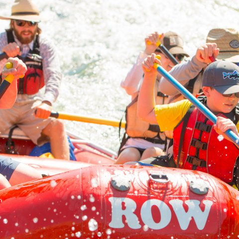 red whitewater raft with paddlers