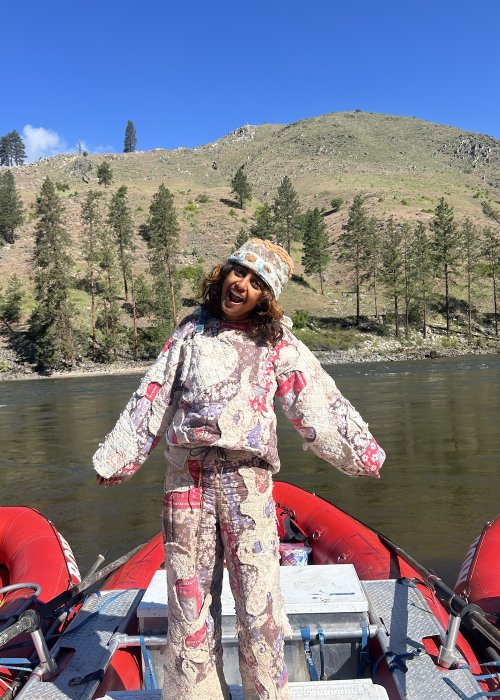ROW employee smiling on a whitewater raft.