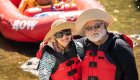 couple standing in front of red raft