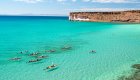 Kayakers paddling across crystal clear water in La Paz, Baja.