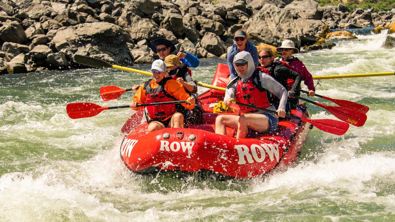 A view of customers in a ROW Adventures raft going through a rapid on the Snake River.