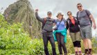 Four hikers smiling while hiking the Inca Trail in Peru
