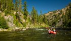 A red raft in the lower right corner of the frame on the Middle Fork Salmon River