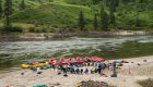 people sitting in a circle near a river