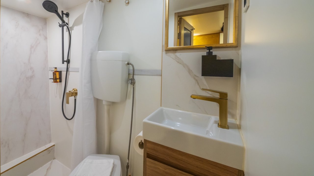 The bathroom of a yacht with a sink and shower.