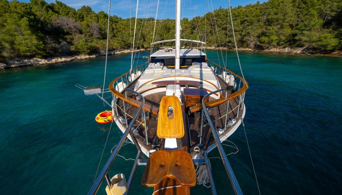 Bow view of a yacht, showing the sun deck and water toys.